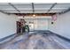 Well-lit garage featuring storage racks, bicycles, and a refrigerator at 14120 E Warren Pl, Aurora, CO 80014