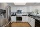 Functional kitchen featuring modern appliances, bright cabinets, and plenty of counter space, ideal for home cooking at 14120 E Warren Pl, Aurora, CO 80014