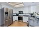 Well-maintained kitchen with stainless steel appliances, light colored cabinets, and ample counter space for cooking at 14120 E Warren Pl, Aurora, CO 80014