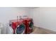 Functional laundry area with red modern front-load washer and dryer at 14120 E Warren Pl, Aurora, CO 80014