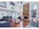 Bright living room with hardwood floors, fireplace, soaring ceilings, and a seamless transition to the dining area at 14120 E Warren Pl, Aurora, CO 80014