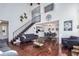 Elegant living room featuring vaulted ceilings, hardwood floors, and an open staircase leading to the upper level at 14120 E Warren Pl, Aurora, CO 80014
