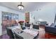 Open concept living space with a dining area leading into the living room with large windows and hardwood floors at 14120 E Warren Pl, Aurora, CO 80014