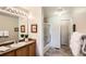 Clean bathroom with a single sink, shower with glass door, and neutral-toned walls at 6114 Salvia Ln, Arvada, CO 80403