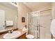 Well-lit bathroom featuring a single sink and shower with glass sliding doors at 6114 Salvia Ln, Arvada, CO 80403