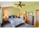 Comfortable bedroom featuring a bed with blue checkered pillows and wood furnishings at 6114 Salvia Ln, Arvada, CO 80403