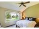 Bright bedroom with a ceiling fan, large windows, and a view of the front yard at 6114 Salvia Ln, Arvada, CO 80403
