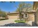 Home exterior showing the driveway and garage with beautiful landscaping and mature trees at 6114 Salvia Ln, Arvada, CO 80403