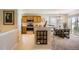 Bright kitchen with stainless steel appliances, wood cabinetry, and an adjacent dining area at 6114 Salvia Ln, Arvada, CO 80403