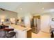 Open concept kitchen with a breakfast bar and stainless steel appliances, ideal for entertaining at 6114 Salvia Ln, Arvada, CO 80403