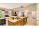 Open kitchen area with a view of the living room featuring a fireplace and vaulted ceilings at 6114 Salvia Ln, Arvada, CO 80403