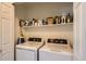 Laundry room with a shelf, washer, and dryer at 6114 Salvia Ln, Arvada, CO 80403