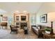 Cozy living room with a fireplace, comfortable seating, and lots of natural light at 6114 Salvia Ln, Arvada, CO 80403