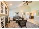 Bright living room with vaulted ceilings, a cozy fireplace, and a comfortable seating arrangement at 6114 Salvia Ln, Arvada, CO 80403