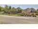 Inviting neighborhood entrance with stone signage and well-kept landscaping along the street at 6114 Salvia Ln, Arvada, CO 80403