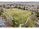 An aerial view showcases a neighborhood park with winding paths and a baseball field at 11930 E Lake Cir, Greenwood Village, CO 80111