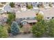 An aerial view displaying a lovely home with a covered deck surrounded by mature trees at 11930 E Lake Cir, Greenwood Village, CO 80111