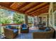 Comfortable back porch is furnished with outdoor chairs, a rug, and string lights at 11930 E Lake Cir, Greenwood Village, CO 80111
