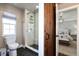 Bathroom featuring a glass shower and a sliding barn door entrance leading to the Primary bedroom at 11930 E Lake Cir, Greenwood Village, CO 80111