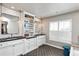 Bathroom featuring dual vanities, white cabinets, and stylish fixtures at 11930 E Lake Cir, Greenwood Village, CO 80111