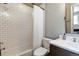 Functional bathroom with a shower-tub combo, white subway tile, and a modern vanity at 11930 E Lake Cir, Greenwood Village, CO 80111