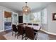 Cozy dining area featuring an outdoor view with wood table, modern lighting, and a sliding door at 11930 E Lake Cir, Greenwood Village, CO 80111