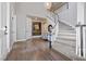 Bright foyer showcases a curved staircase, wood floors, and a stylish light fixture at 11930 E Lake Cir, Greenwood Village, CO 80111