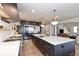 Bright, modern kitchen features a large island with seating, stainless steel appliances, and open floorplan at 11930 E Lake Cir, Greenwood Village, CO 80111
