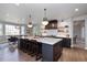 Modern kitchen features a large center island, stylish lighting, and stainless steel appliances at 11930 E Lake Cir, Greenwood Village, CO 80111