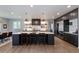 Beautiful kitchen features a large island with seating, wooden floors, and recessed lighting at 11930 E Lake Cir, Greenwood Village, CO 80111
