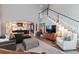 Inviting living room with staircase, modern decor, and seamless flow to the kitchen at 11930 E Lake Cir, Greenwood Village, CO 80111
