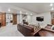 Comfortable living room has a sliding barn door, leather furniture, and modern decor at 11930 E Lake Cir, Greenwood Village, CO 80111