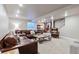 Spacious living room includes a leather sofa, rustic coffee table, and cozy furnishings at 11930 E Lake Cir, Greenwood Village, CO 80111
