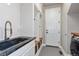 Mud room with built-in storage, coat hooks, bench, and stylish fixtures at 11930 E Lake Cir, Greenwood Village, CO 80111