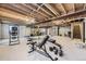 Unfinished basement features exposed beams and versatile space for customization and storage at 1773 S Union Blvd, Lakewood, CO 80228