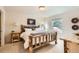 Bedroom featuring a rustic wood bed frame, side table and a large window at 1773 S Union Blvd, Lakewood, CO 80228