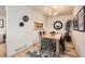 Dining area featuring wood floors, modern light fixture and adjacent kitchen at 1773 S Union Blvd, Lakewood, CO 80228