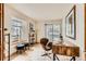 Bright home office with a wooden desk, chair, and ample natural light from large windows at 1773 S Union Blvd, Lakewood, CO 80228