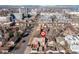 Aerial view of property in urban area with neighborhood, garage, and city skyline in the background at 1556 Osceola St, Denver, CO 80204