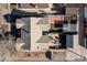 An aerial view showing the house, backyard with patio furniture, grass and garden areas, the garage, and front yard at 1556 Osceola St, Denver, CO 80204