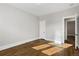 A bright bedroom featuring hardwood floors and a white door at 1556 Osceola St, Denver, CO 80204