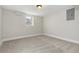 Finished basement bedroom with plush neutral carpeting, a window, and fresh paint at 1556 Osceola St, Denver, CO 80204