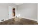 A bright bedroom featuring hardwood floors and a white door at 1556 Osceola St, Denver, CO 80204