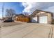 A two-car garage with a long driveway providing ample parking, complemented by a well-kept lawn at 1556 Osceola St, Denver, CO 80204