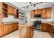 Kitchen featuring dark wood cabinets, granite countertops, stainless appliances, and tile floors at 1556 Osceola St, Denver, CO 80204