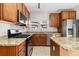 Kitchen with stainless appliances, including gas range, island, and granite countertops at 1556 Osceola St, Denver, CO 80204