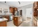 Well-lit kitchen boasting a center island, granite countertops, stainless appliances, and tile floors at 1556 Osceola St, Denver, CO 80204