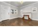 Inviting living room with white walls, hardwood floors, fireplace, and natural light at 1556 Osceola St, Denver, CO 80204