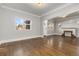 Open living room with hardwood floors, a decorative fireplace and plenty of natural light at 1556 Osceola St, Denver, CO 80204