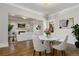 Open floor plan with dining room flowing into the living room; hardwood floors at 1556 Osceola St, Denver, CO 80204